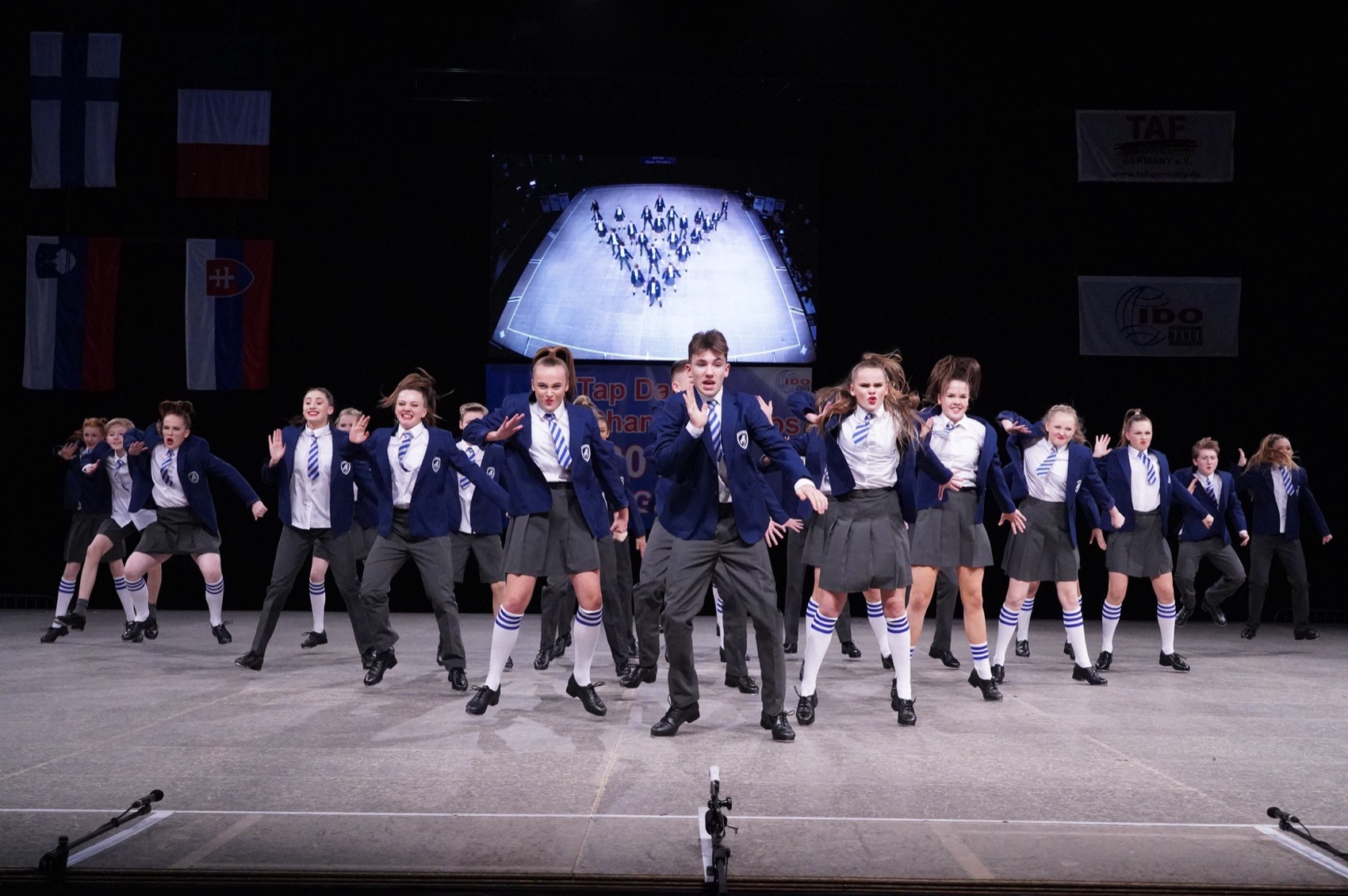 A Team UK formation performing on the championship stage
