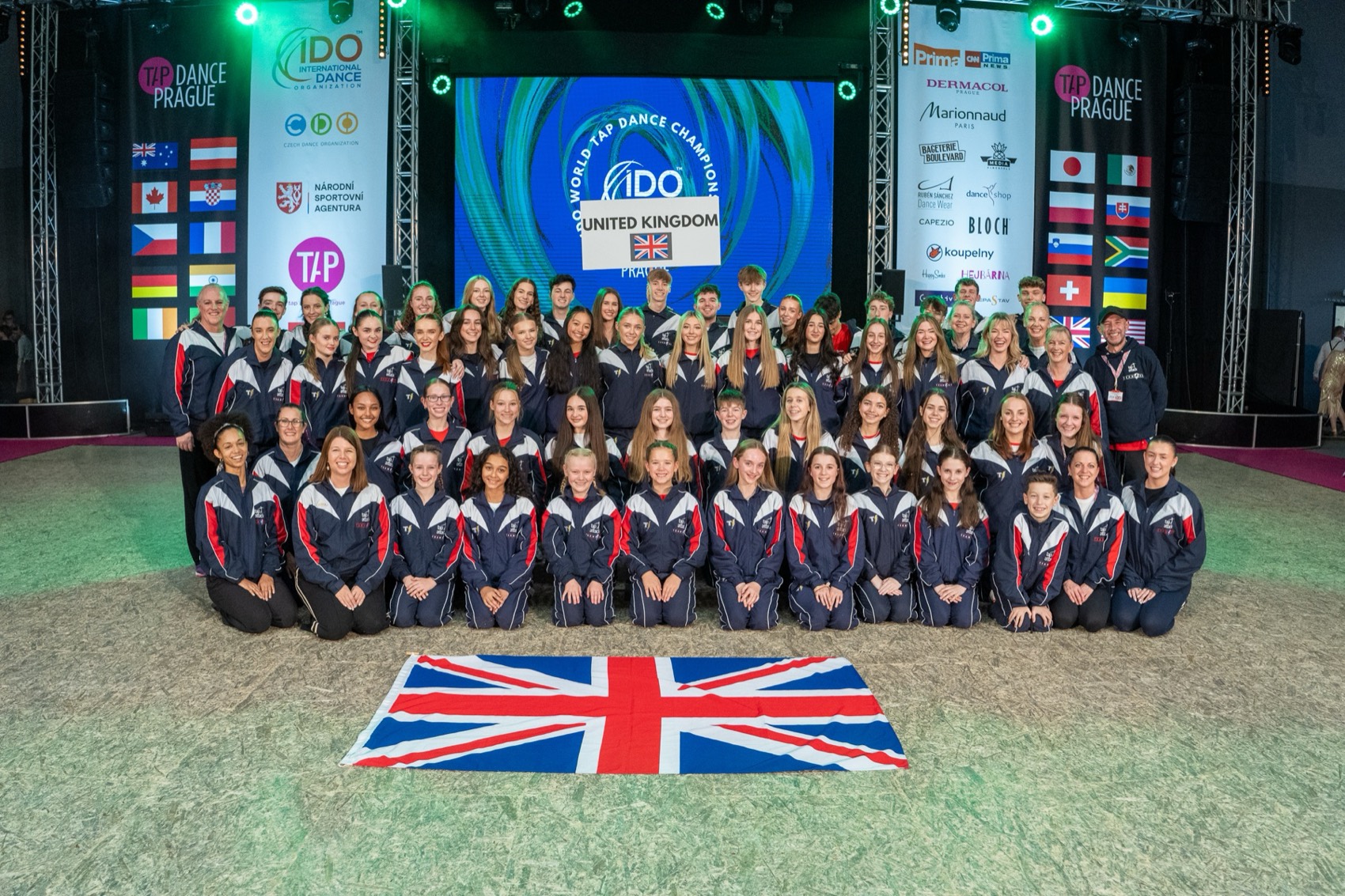 The Team UK squad with the Union flag at an IDO World Tap Dance Championship
